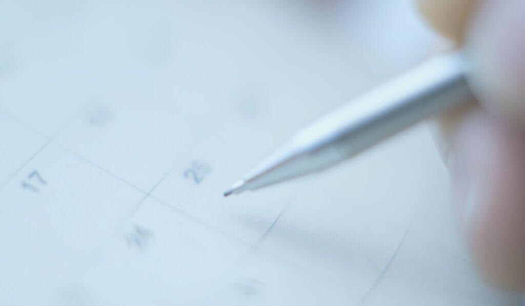 faded calendar with pen writing on a date