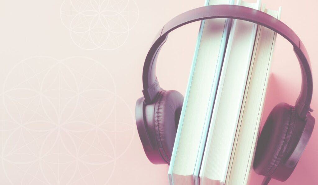 books sitting on a table with headphones on around the books