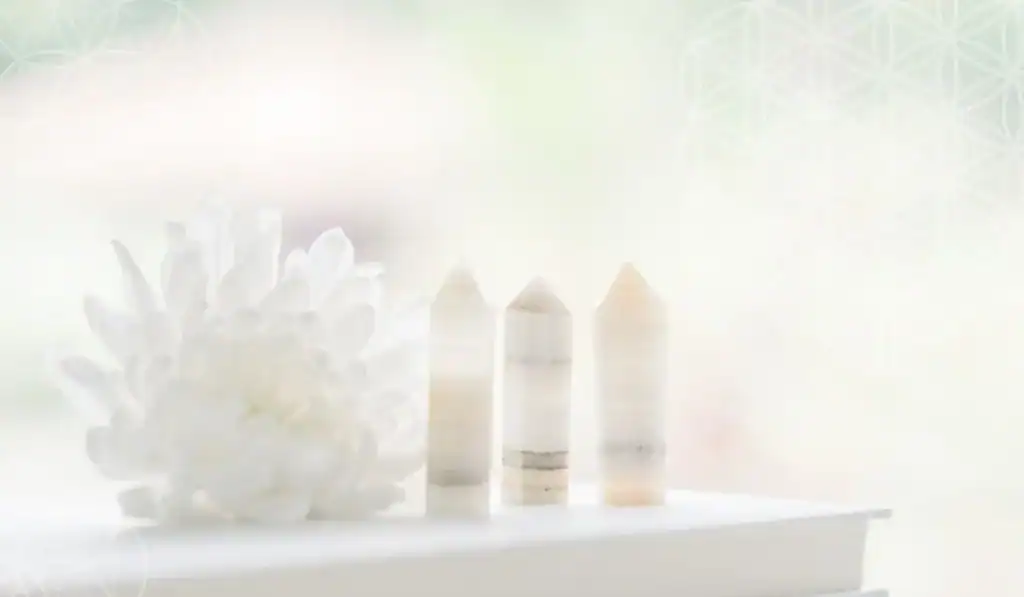 Crystals and white flower on white table