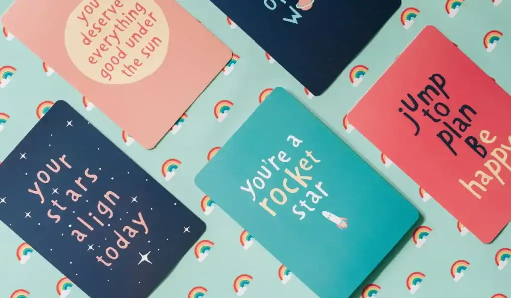 Affirmation cards on green rainbow background