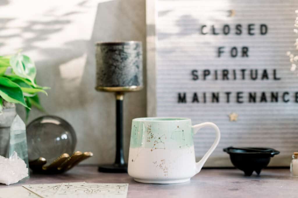 closed for spiritual maintenance sign with cup and  lamp