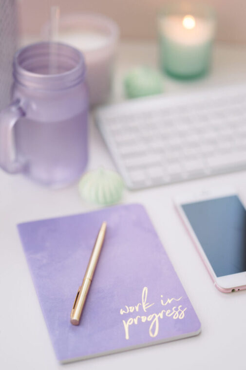 work in progress notebook with keyboard and purple glass